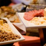 White porcelain appetizer plates with nuts and cheeses