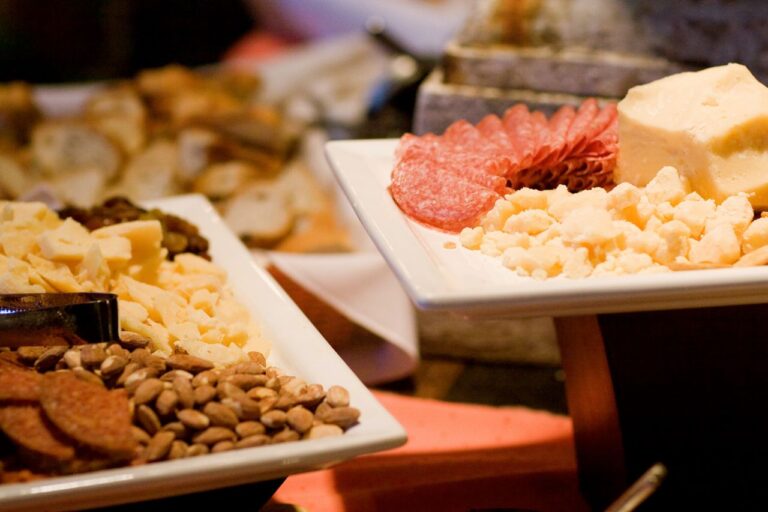 White porcelain appetizer plates with nuts and cheeses